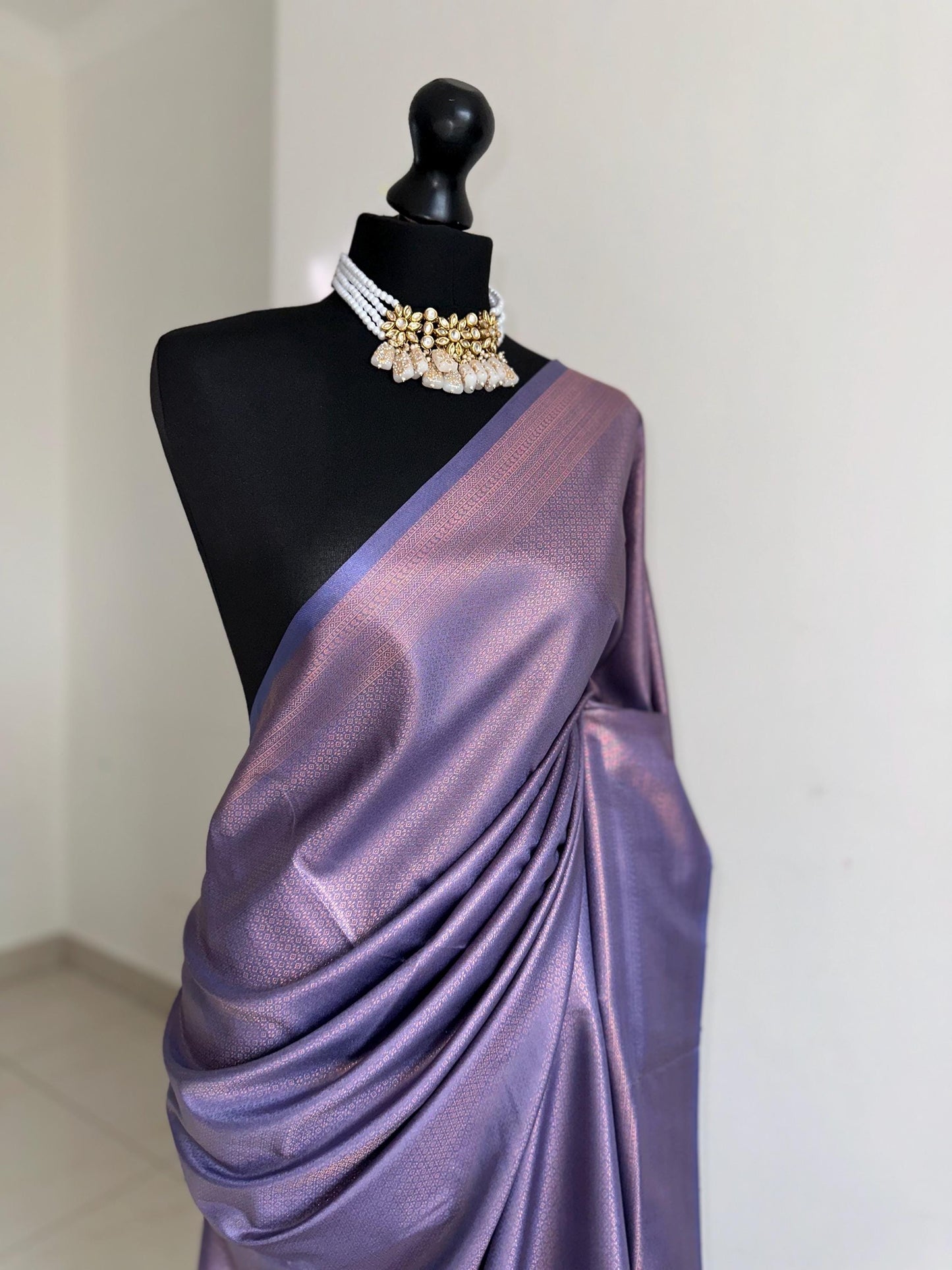 Dusty purple soft silk saree with a copper border and all over sheen. The perfect saree for parties and all traditional events.