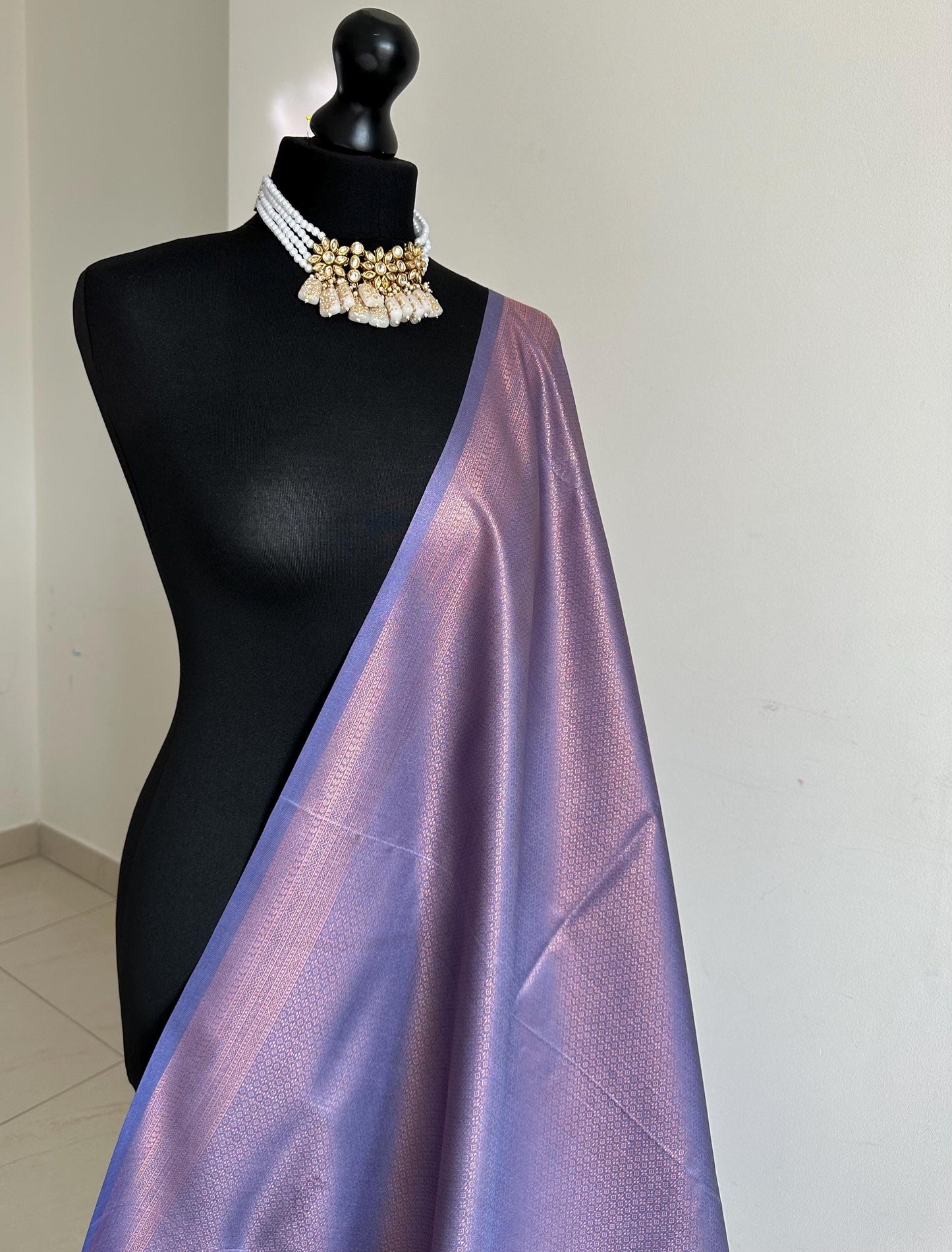 Dusty purple soft silk saree with a copper border and all over sheen. The perfect saree for parties and all traditional events.