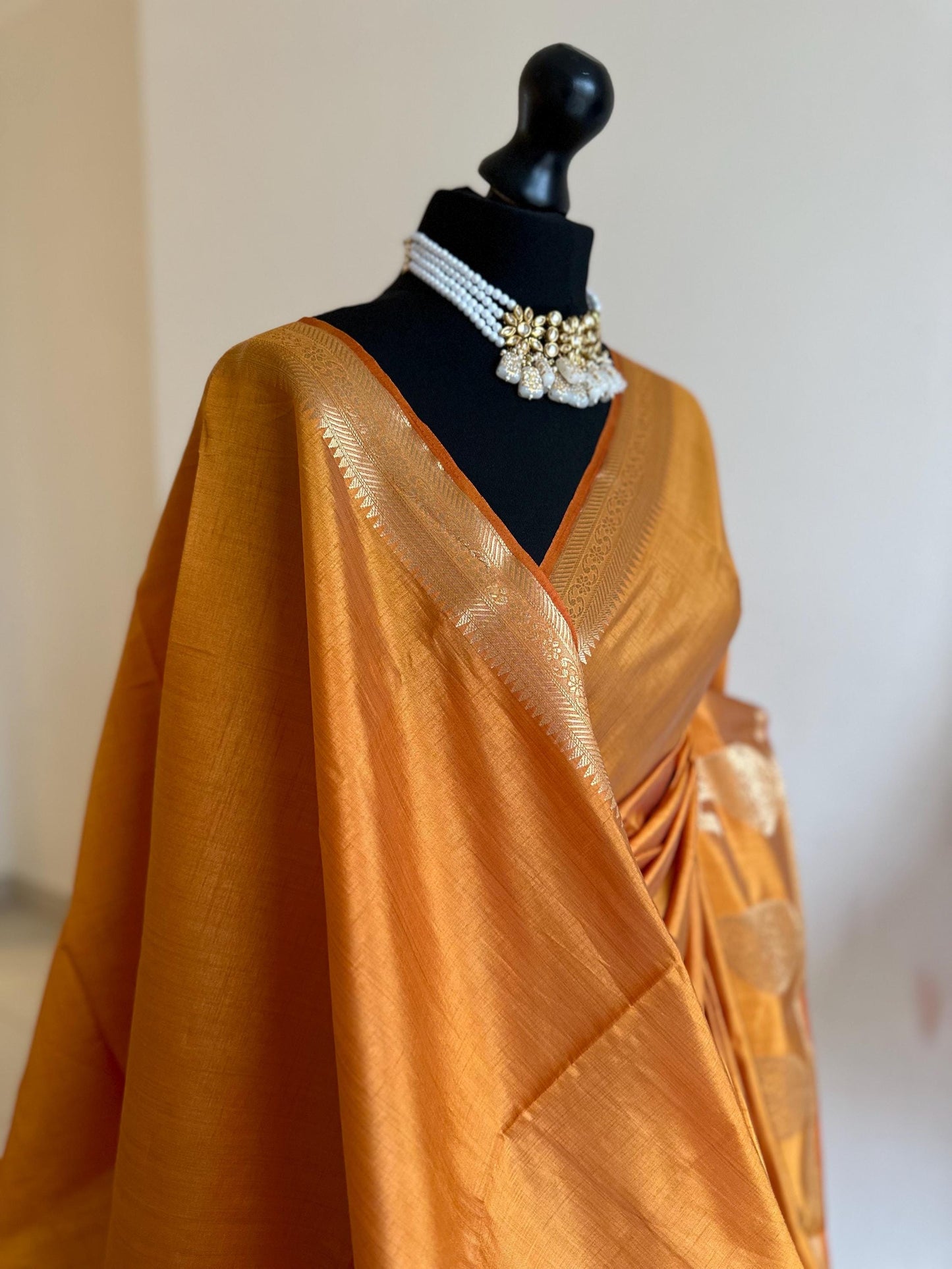 Sandal wood orange soft tussar raw silk saree with unstitched blouse. Gold work on border and pallu. Statement saree and colour.