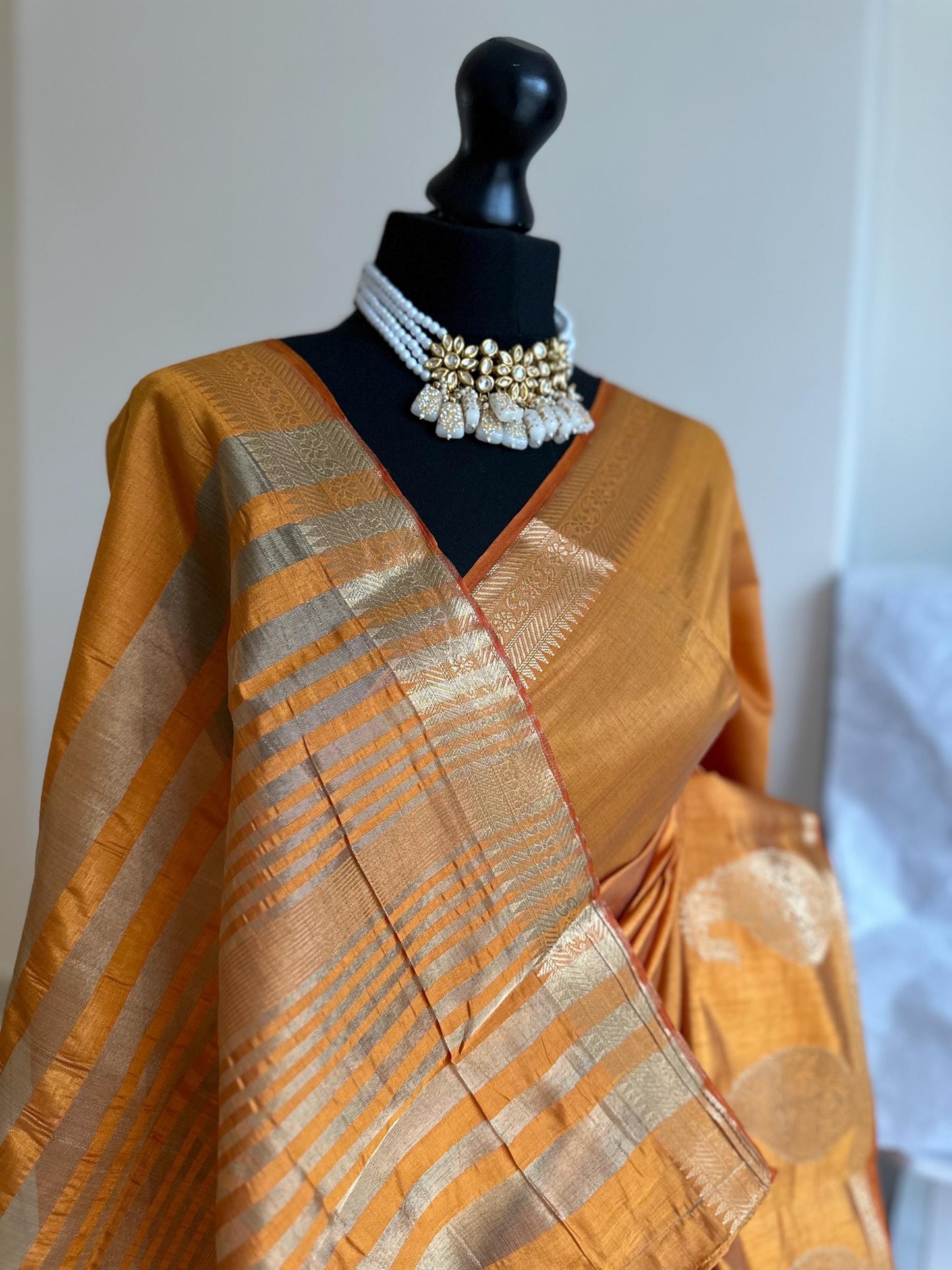 Sandal wood orange soft tussar raw silk saree with unstitched blouse. Gold work on border and pallu. Statement saree and colour.