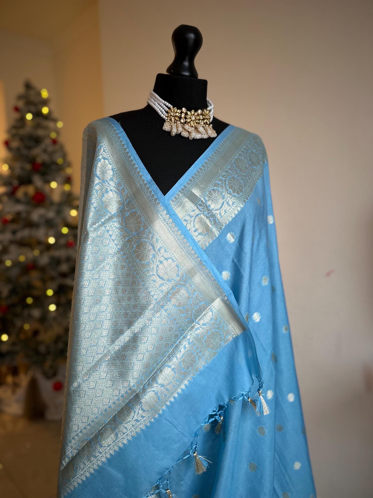 Pale blue banarasi faux gerogette saree. Silver border to create a sophisticated look, worked pallu with tassels with designer blouse