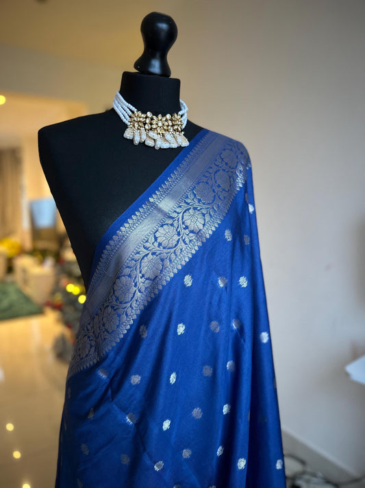 Navy blue banarasi faux gerogette saree with silver border to create a sophisticated look, worked pallu with tassels with designer blouse