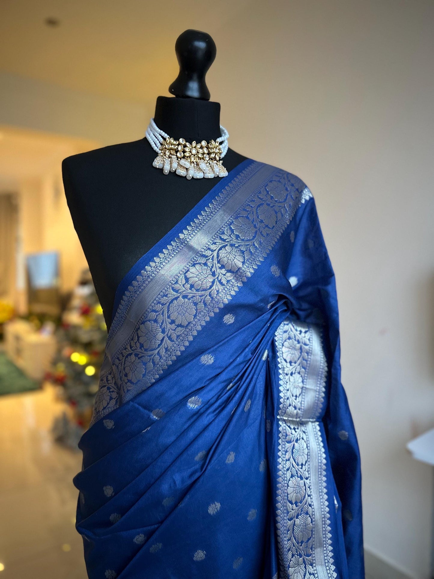 Navy blue banarasi faux gerogette saree with silver border to create a sophisticated look, worked pallu with tassels with designer blouse