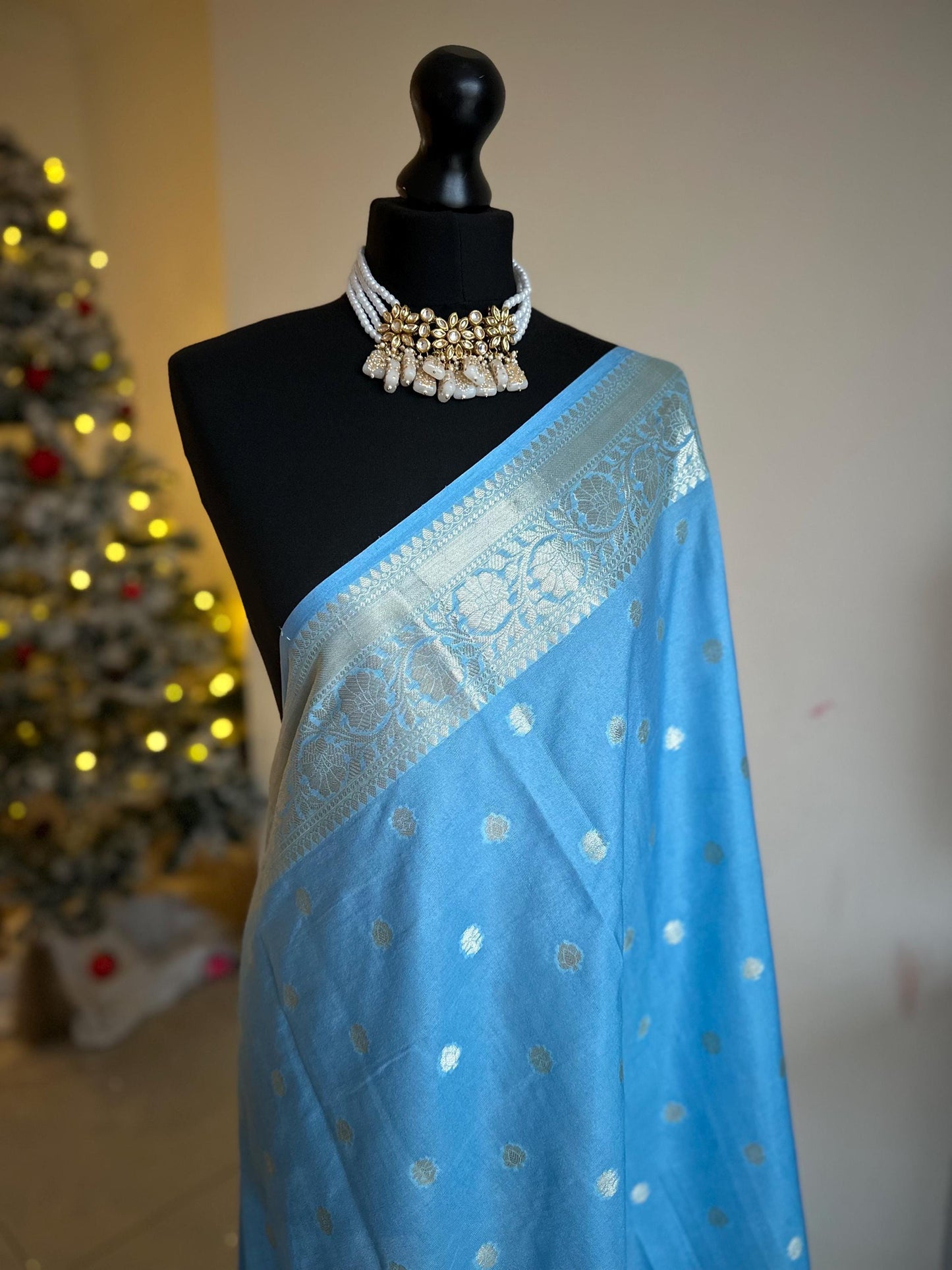 Pale blue banarasi faux gerogette saree. Silver border to create a sophisticated look, worked pallu with tassels with designer blouse