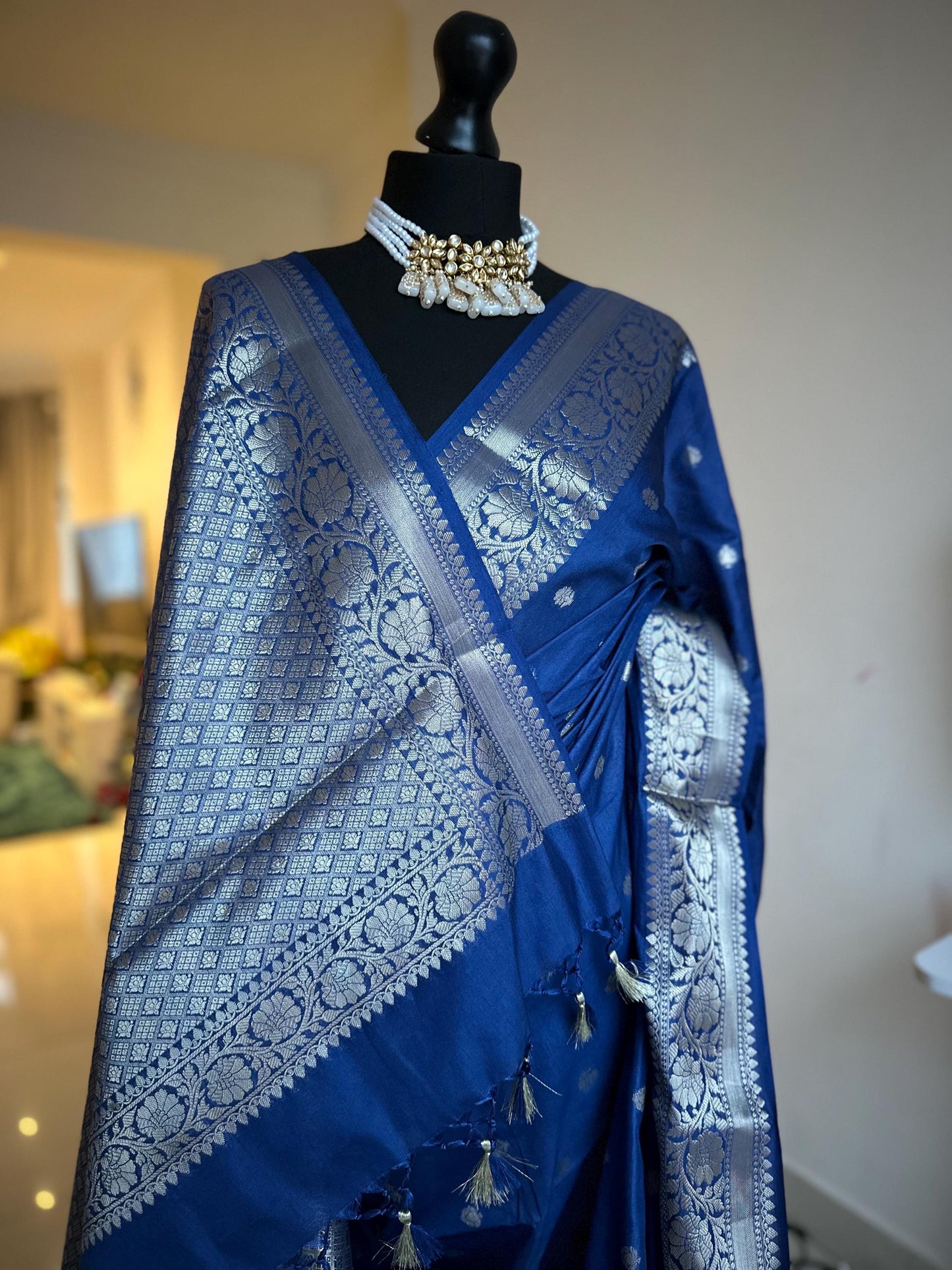 Navy blue banarasi faux gerogette saree with silver border to create a sophisticated look, worked pallu with tassels with designer blouse