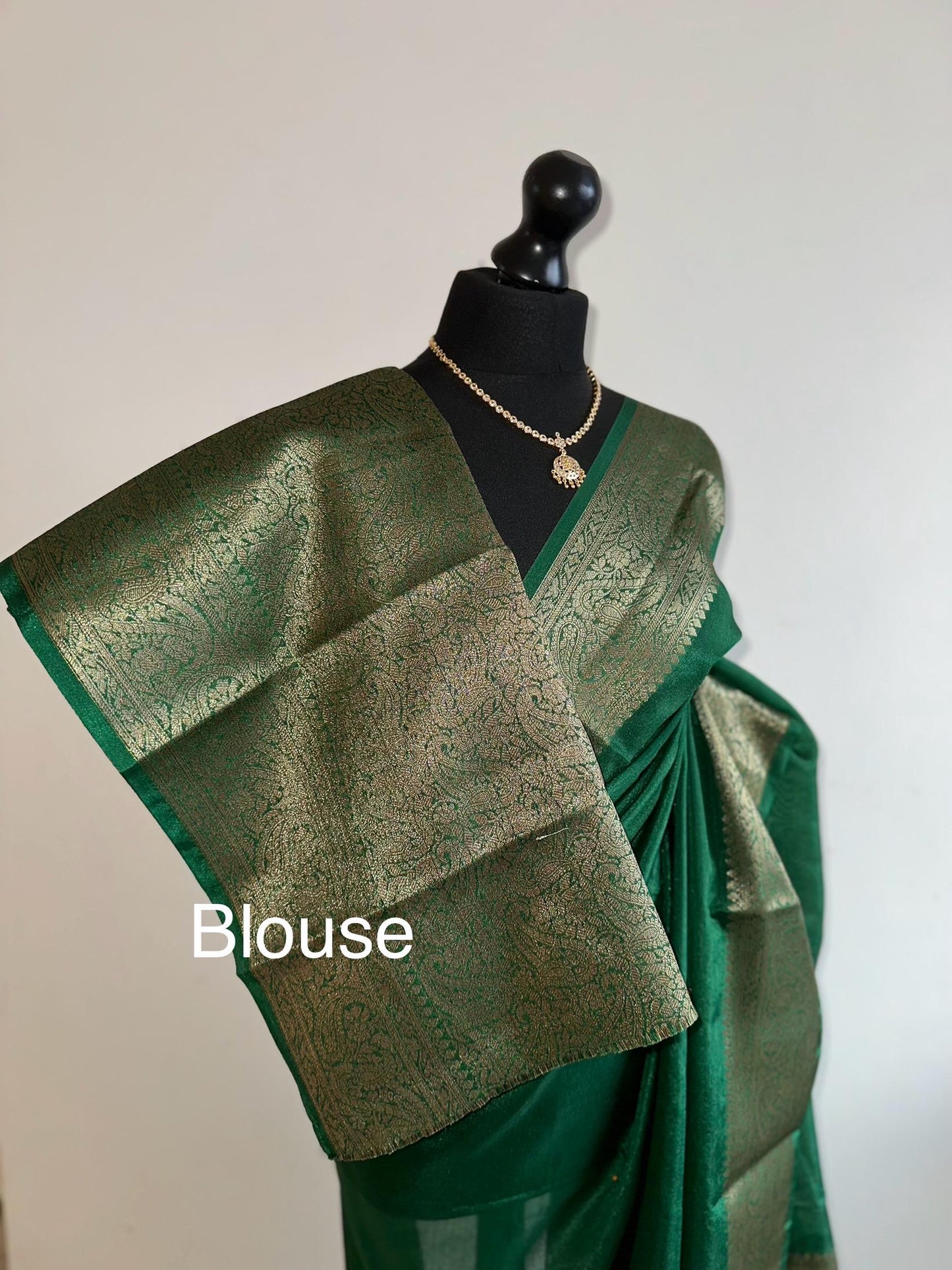 Green chiffon semi silk saree with antique gold border.