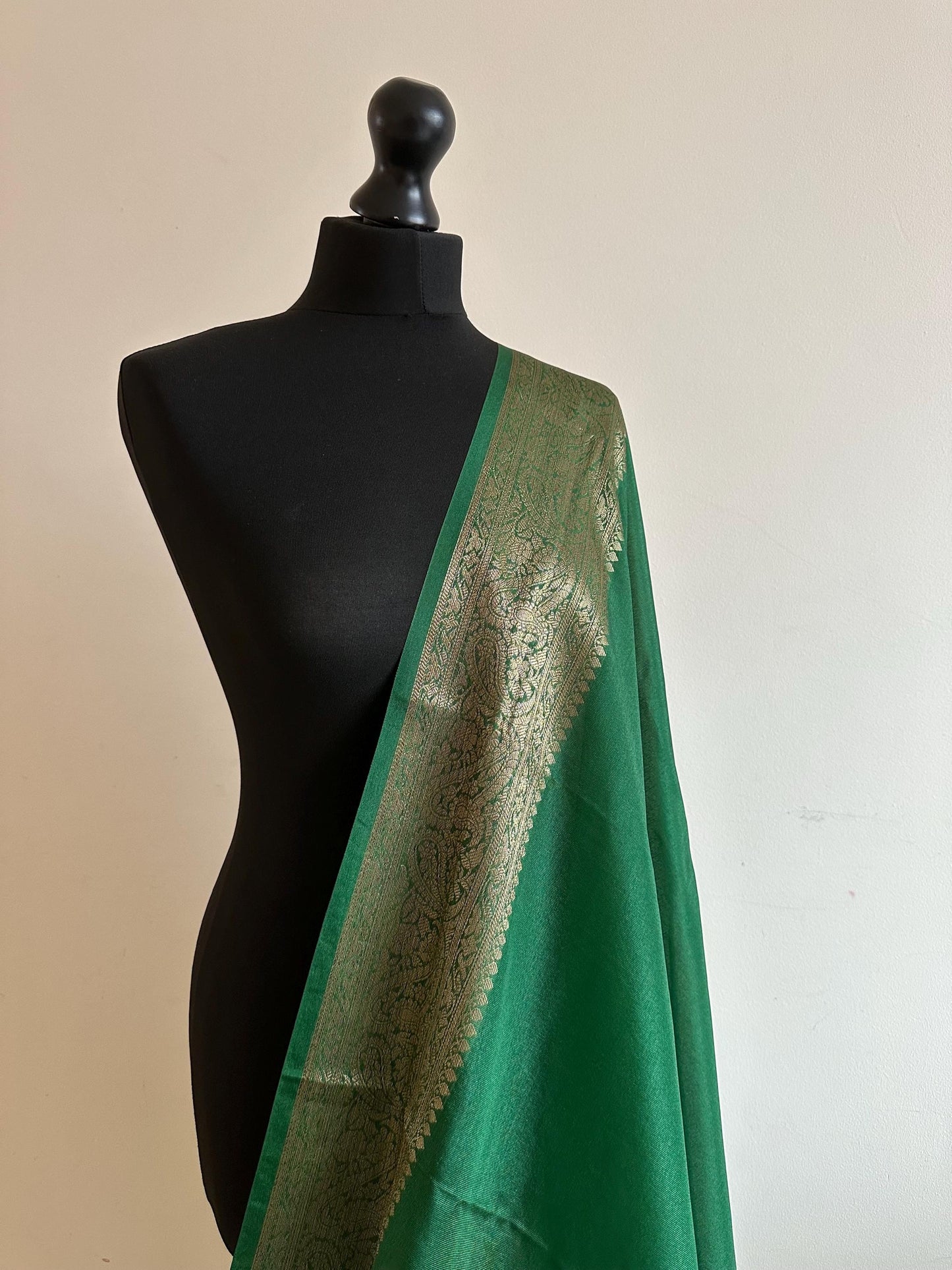 Green chiffon semi silk saree with antique gold border.