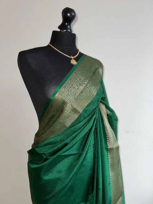 Green chiffon semi silk saree with antique gold border.