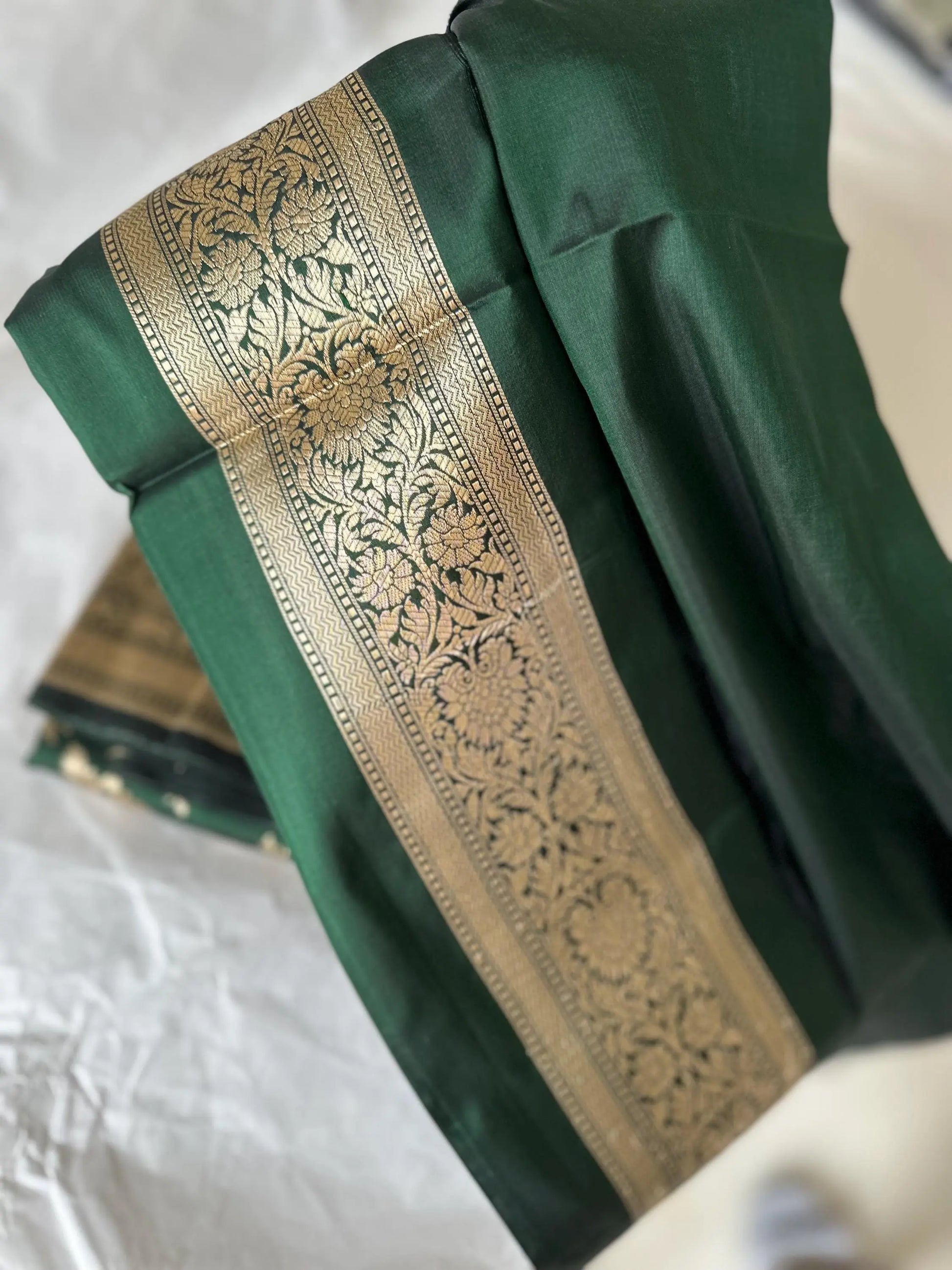 Elegant dark green pure silk Banarasi saree with intricate gold zari work and floral motifs, perfect for weddings and festive occasions Etsy