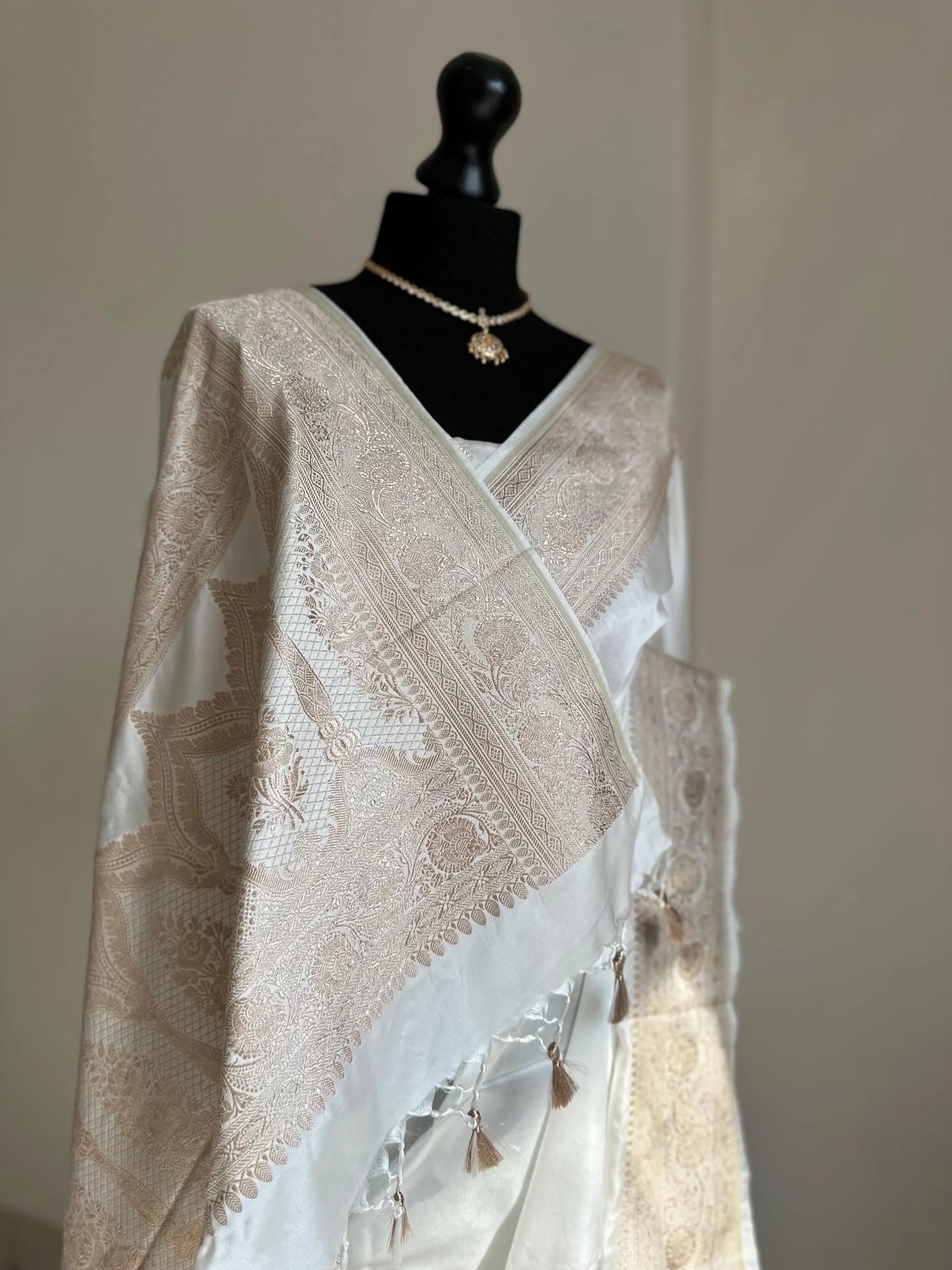 Banarasi silk white katan wedding saree with champagne gold zari. Whit traditional silk saree with designer jaal patterned blouse. -  LaiLai Sarees