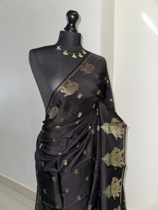 Black semi silk saree with subtle gold zari elephant border and polka dot blouse. Traditional Indian saree elegant festive wear