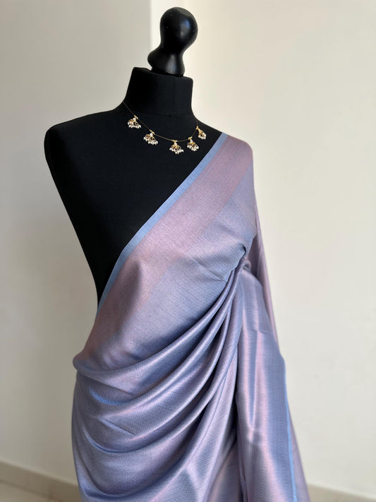 Dusty blue soft silk saree with a copper border and all over sheen. The perfect saree for parties and all traditional events.