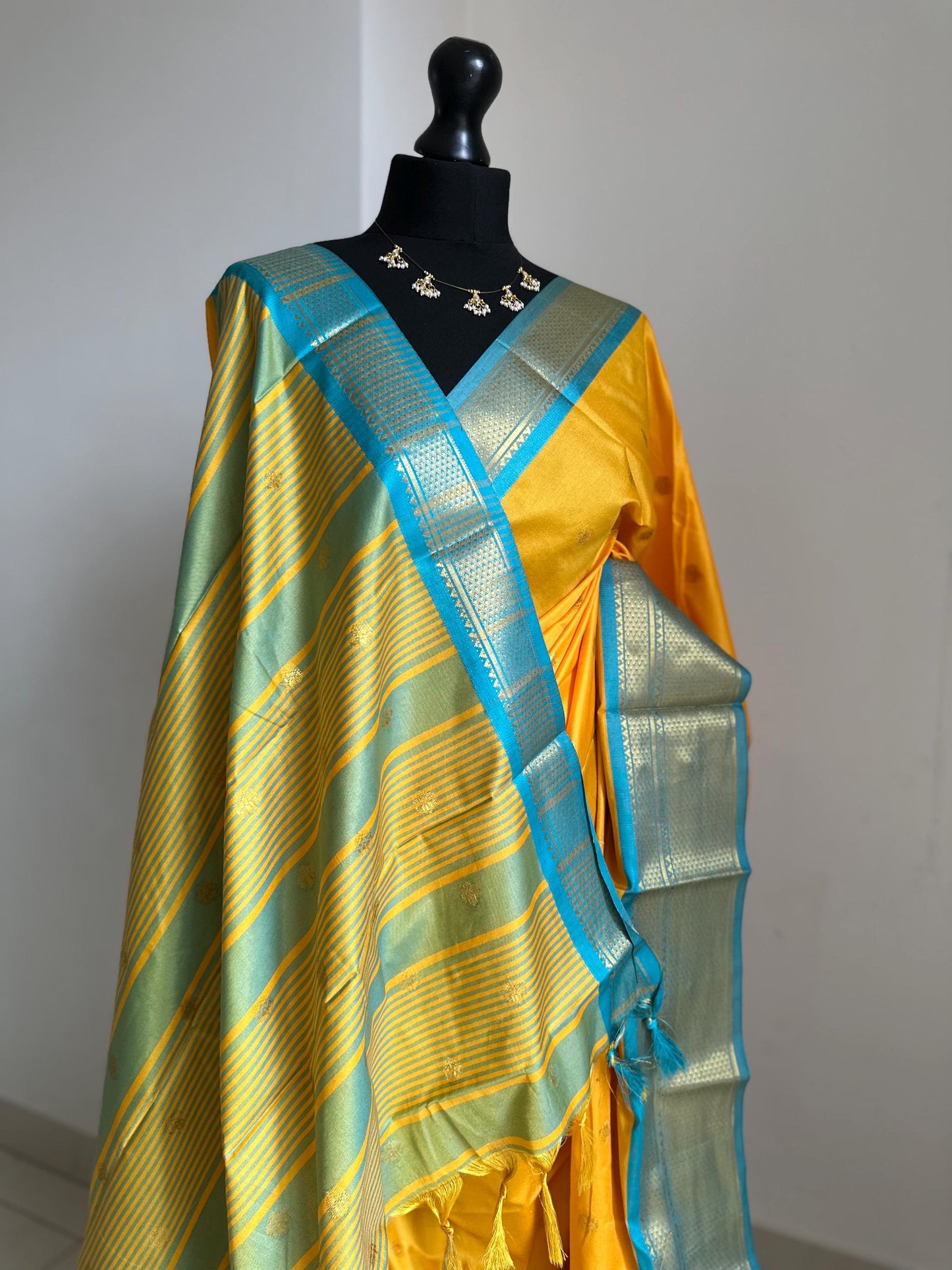 Blue and yellow semi silk saree with gold zari border and buti. Traditional designer saree beautiful colour and design.