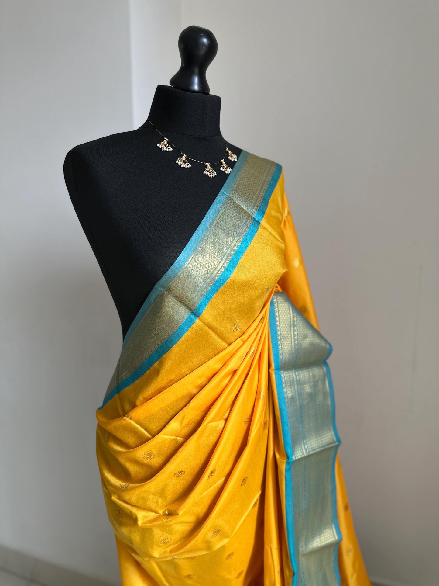 Blue and yellow semi silk saree with gold zari border and buti. Traditional designer saree beautiful colour and design.