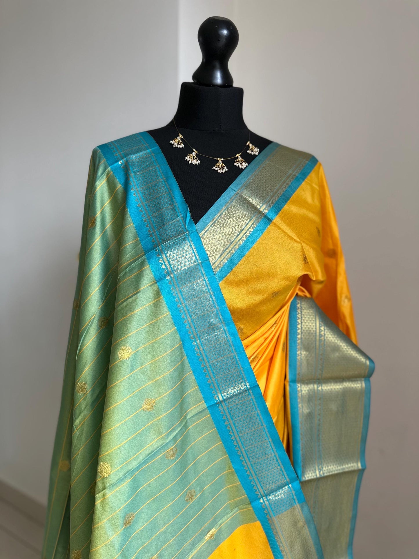 Blue and yellow semi silk saree with gold zari border and buti. Traditional designer saree beautiful colour and design.