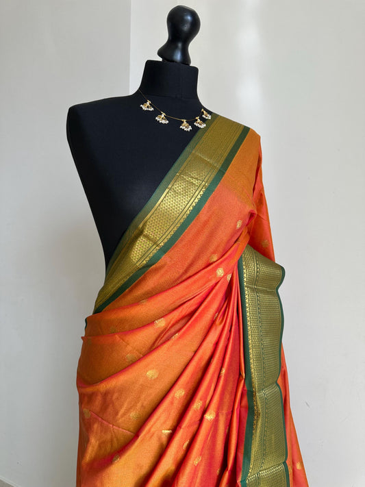 Orange and green semi silk saree with gold zari border and buti. Traditional designer saree beautiful colour and design.