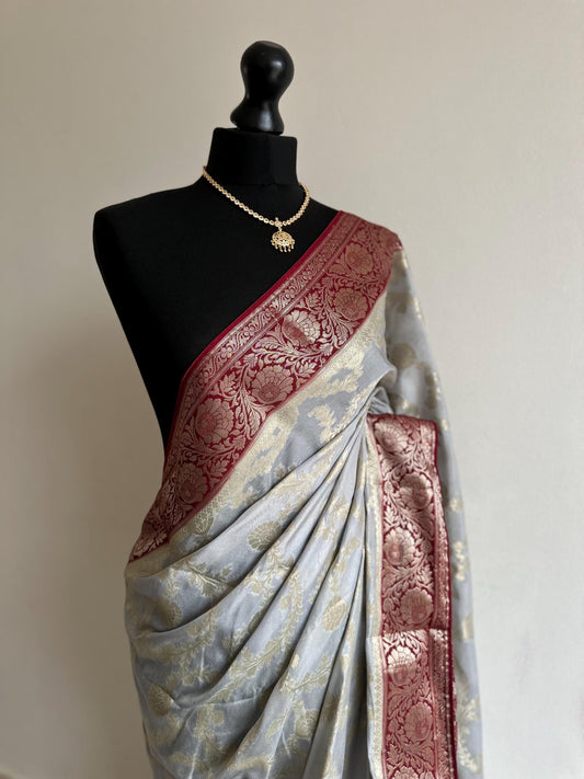 Grey and maroon Banarasi Georgette Silk Saree with all over jaal design. Statement yet elegant saree thats soft to drape and pleat.
