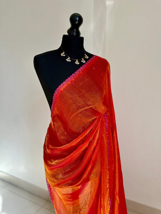 Dual toned coral party designer saree with pink trim border and contrast floral blouse. Unique statement saree can styled with other blouses