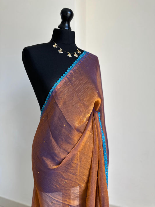 Dual toned rust party designer saree with blue trim border and contrast floral blouse. Unique statement saree can styled with other blouses