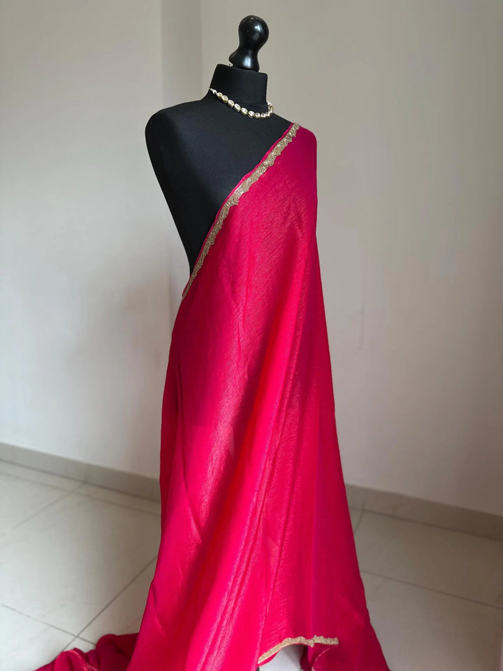 Deep pink chiffon saree with cutdana border. Crafted from soft shimmer chiffon this saree is perfect for parties and evening occasions LaiLai Sarees