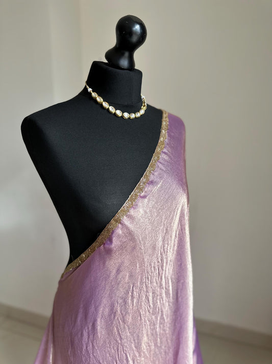 Lilac chiffon saree with cutdana border. Crafted from soft shimmer chiffon this saree is perfect for parties and evening occasions