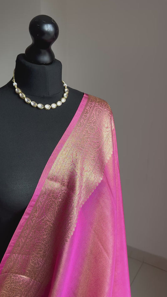 Pink and antique gold semi tissue silk saree. Unstitched brocade blouse.